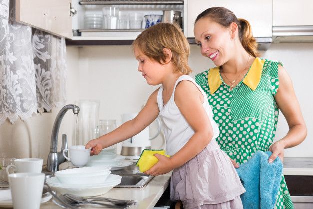 Family cleaning dishes with clean water, treated by Gallup Well Services